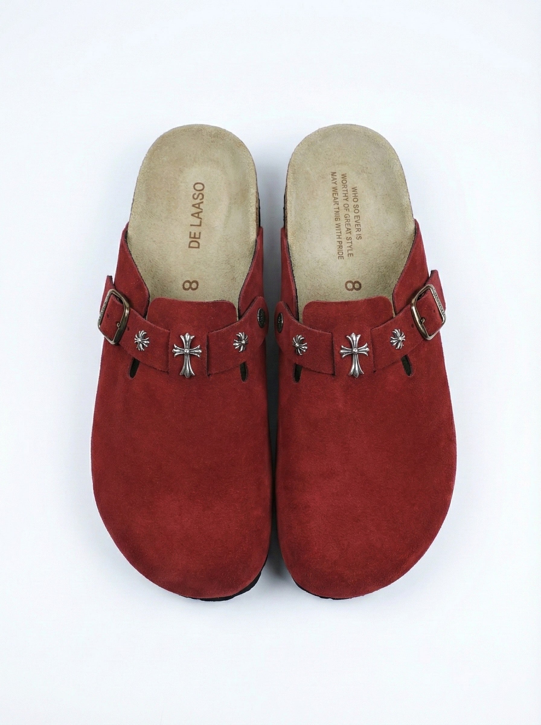 Red clogs with silver buckles on a white background